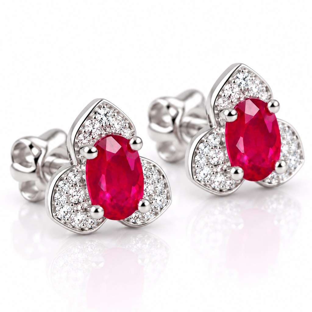 Phimsera natural ruby stud earrings shown at a 45-degree angle with 4×6mm oval red gemstones and surrounding cubic zirconia accents