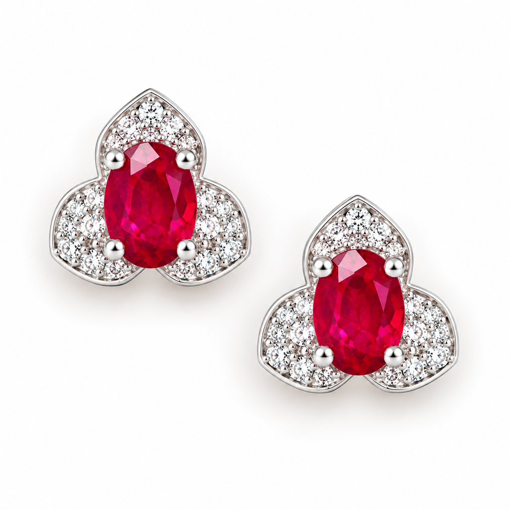 Top-down view of Phimsera 4×6mm natural oval ruby stud earrings with clear cubic zirconia halo and sterling silver setting