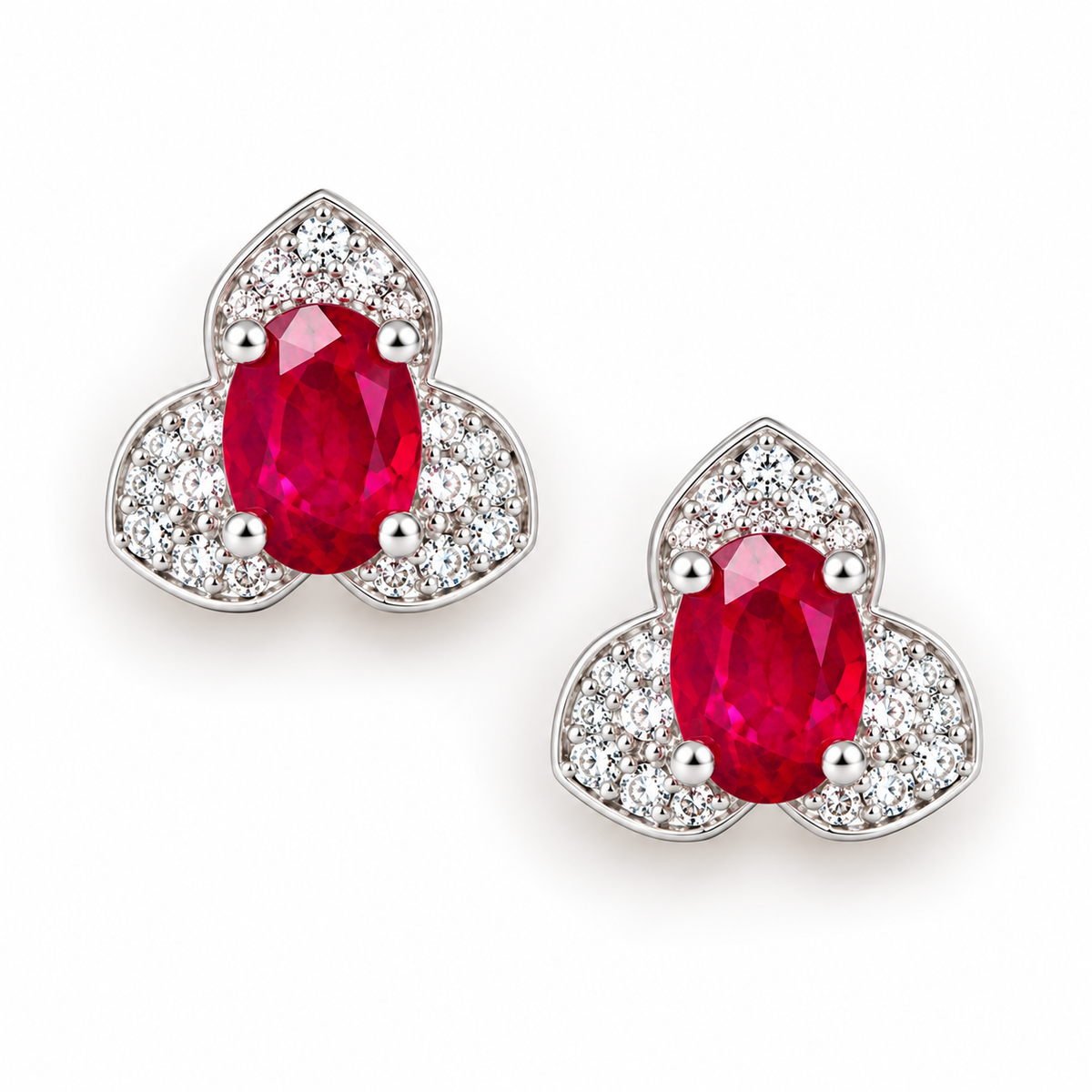 Top-down view of Phimsera 4×6mm natural oval ruby stud earrings with clear cubic zirconia halo and sterling silver setting