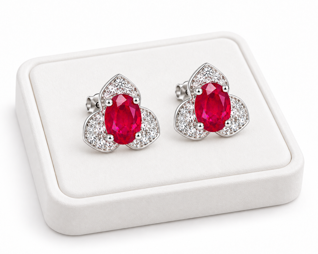 Phimsera 4×6mm natural ruby stud earrings displayed on a white jewelry tray with a clean white background