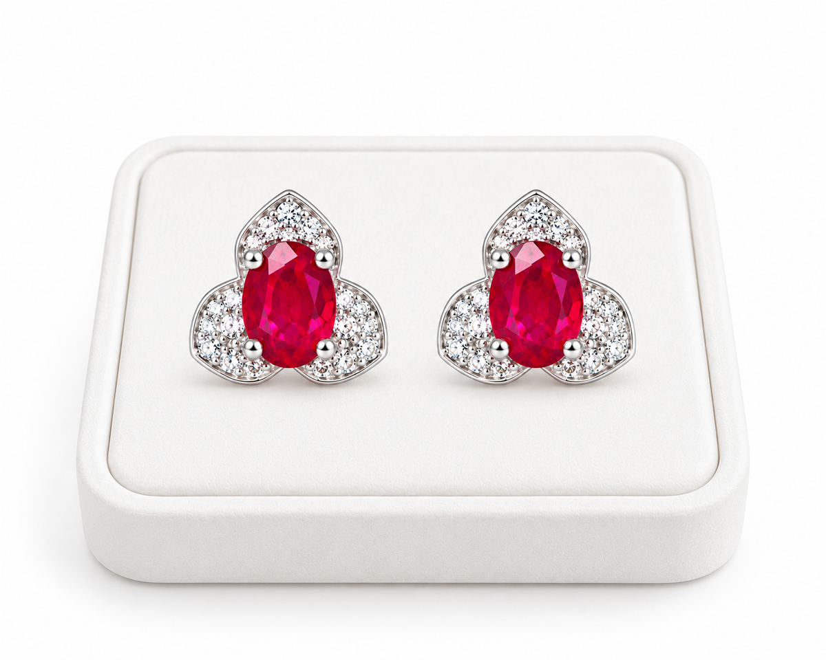 Phimsera 4×6mm natural ruby stud earrings displayed on a white jewelry tray with a clean white background