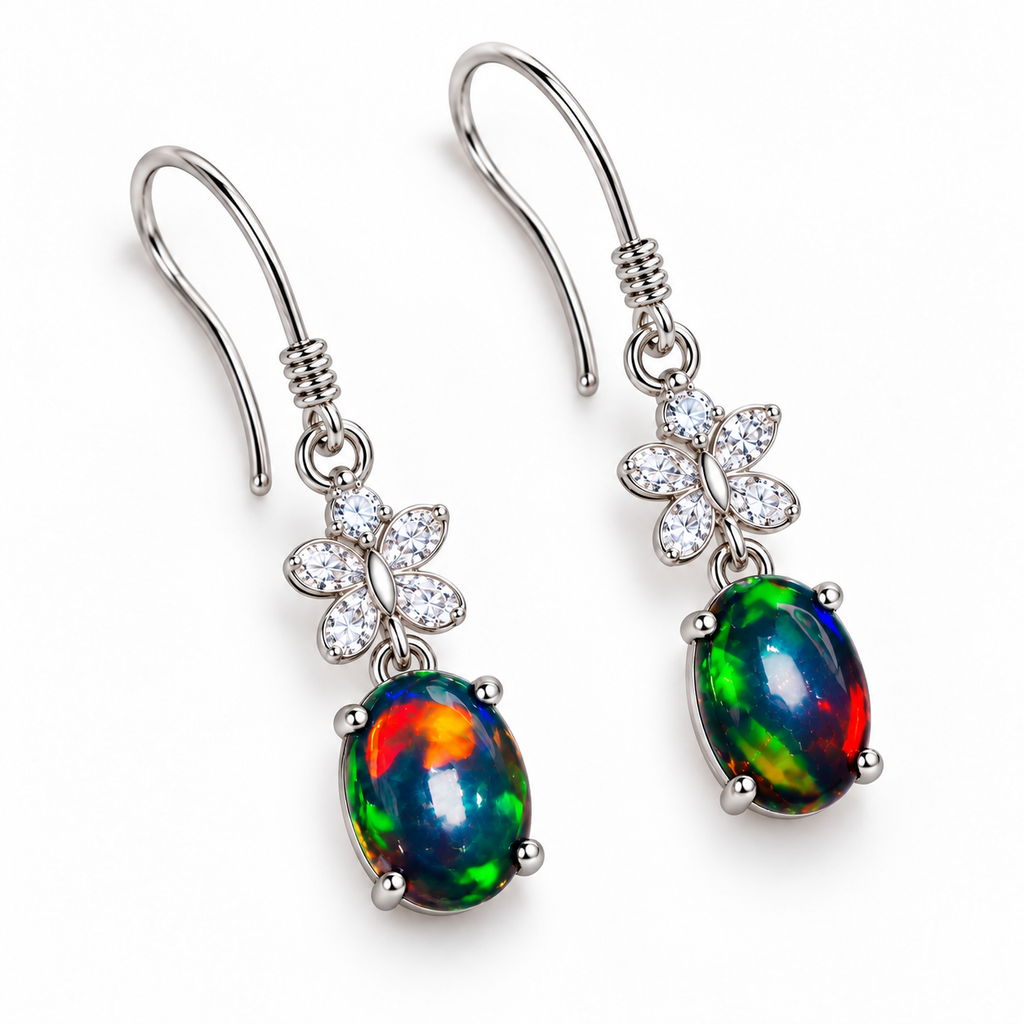 Top-down view of natural black fire opal dangle earrings with 5x7mm oval gemstones