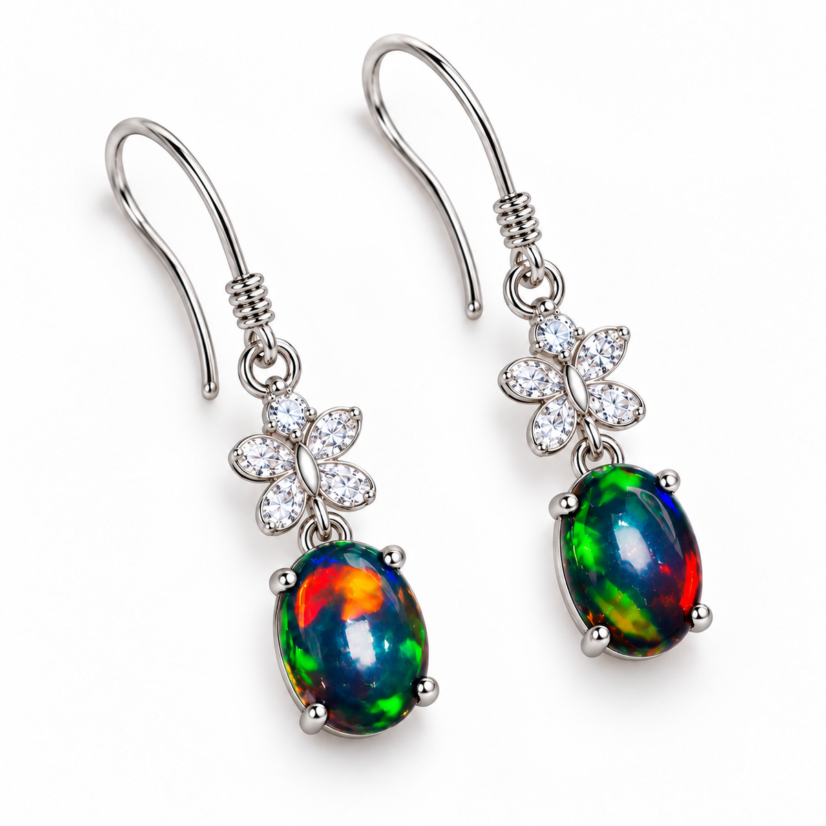 Top-down view of natural black fire opal dangle earrings with 5x7mm oval gemstones