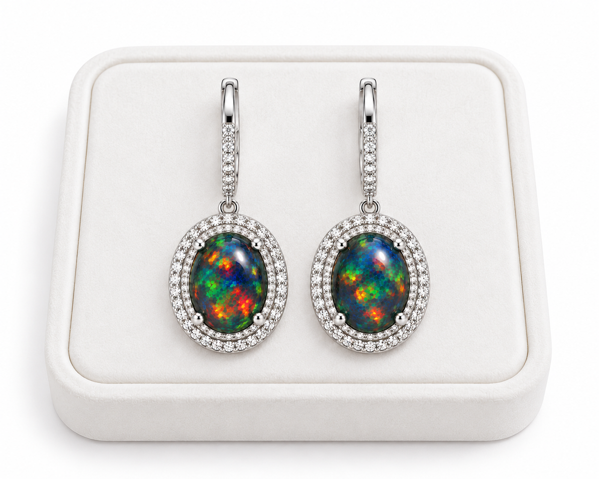Natural Black Fire Opal Earrings with gemstones measuring 8x10mm shown on a flat white velvet tray over a white background.