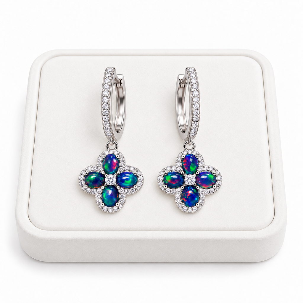 Natural black fire opal hoop earrings with 4x5mm gemstones displayed on a white velvet jewelry tray