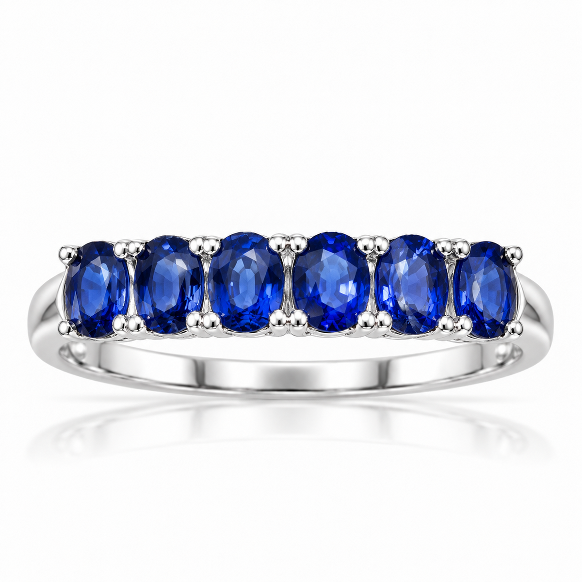 Natural blue sapphire band ring with 3×4mm gemstones in a polished 925 sterling silver setting on a white background by Phimsera