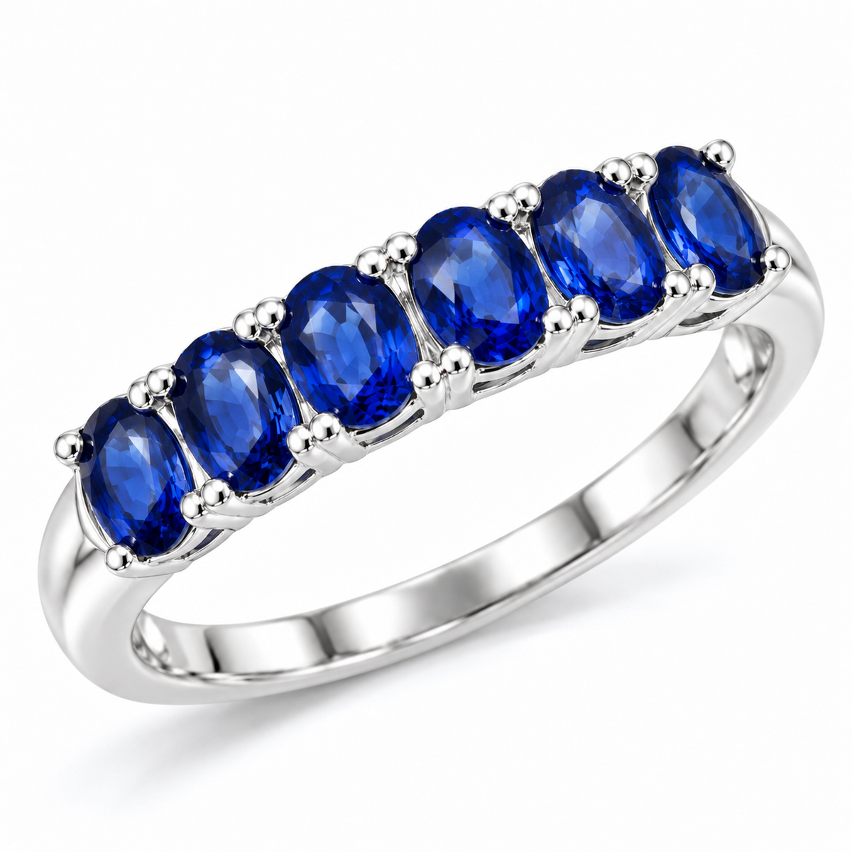 Angled view of a Phimsera natural blue sapphire band ring featuring 3×4mm sapphire gemstones and a polished silver-tone setting