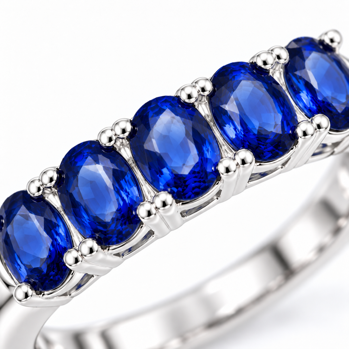 Close-up detail of the natural blue sapphire gemstones measuring 3×4mm in a Phimsera band ring