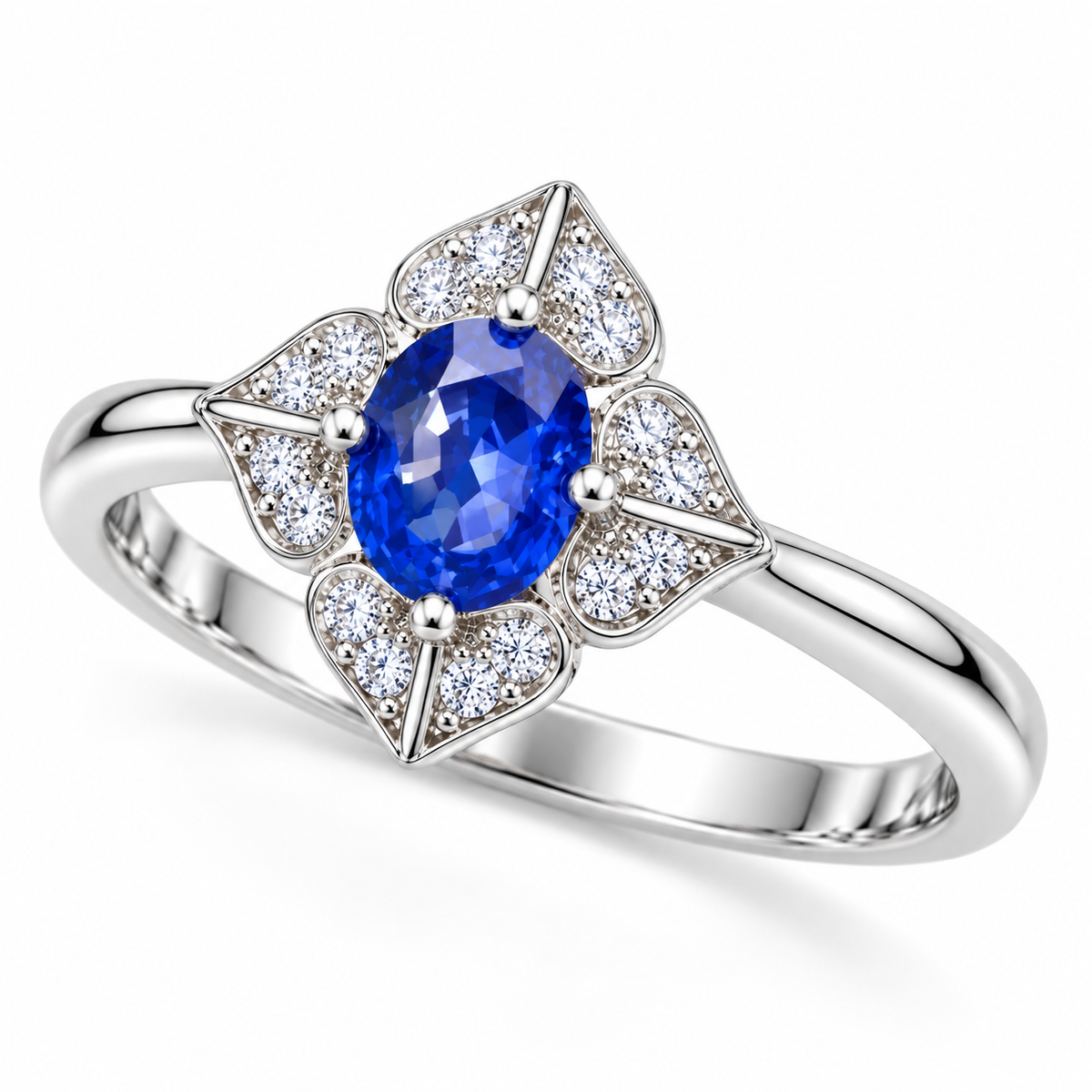 Natural 4×5mm oval blue sapphire ring shown from an angled view with four-petal floral setting