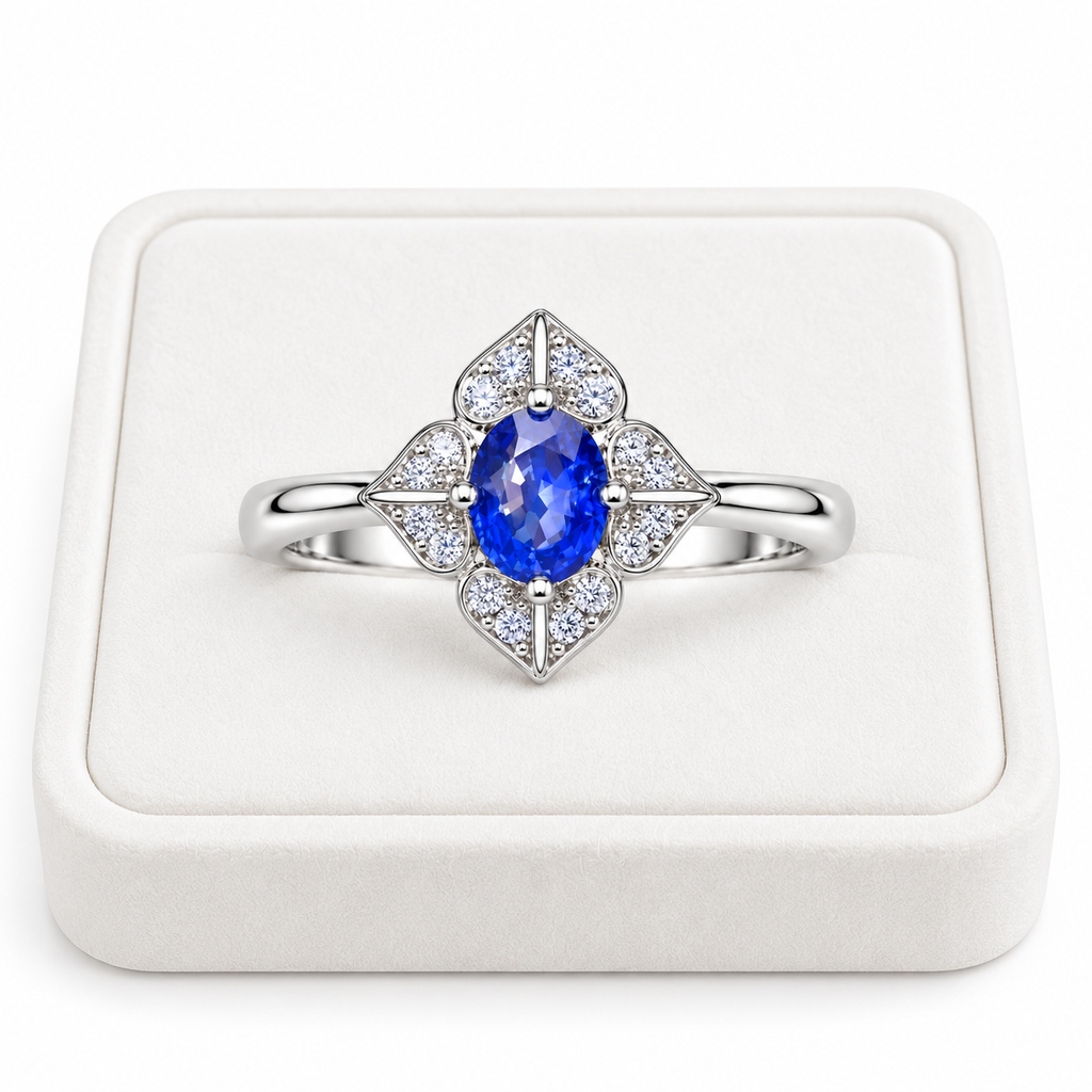 Natural 4×5mm blue sapphire floral ring displayed on a white velvet jewelry tray
