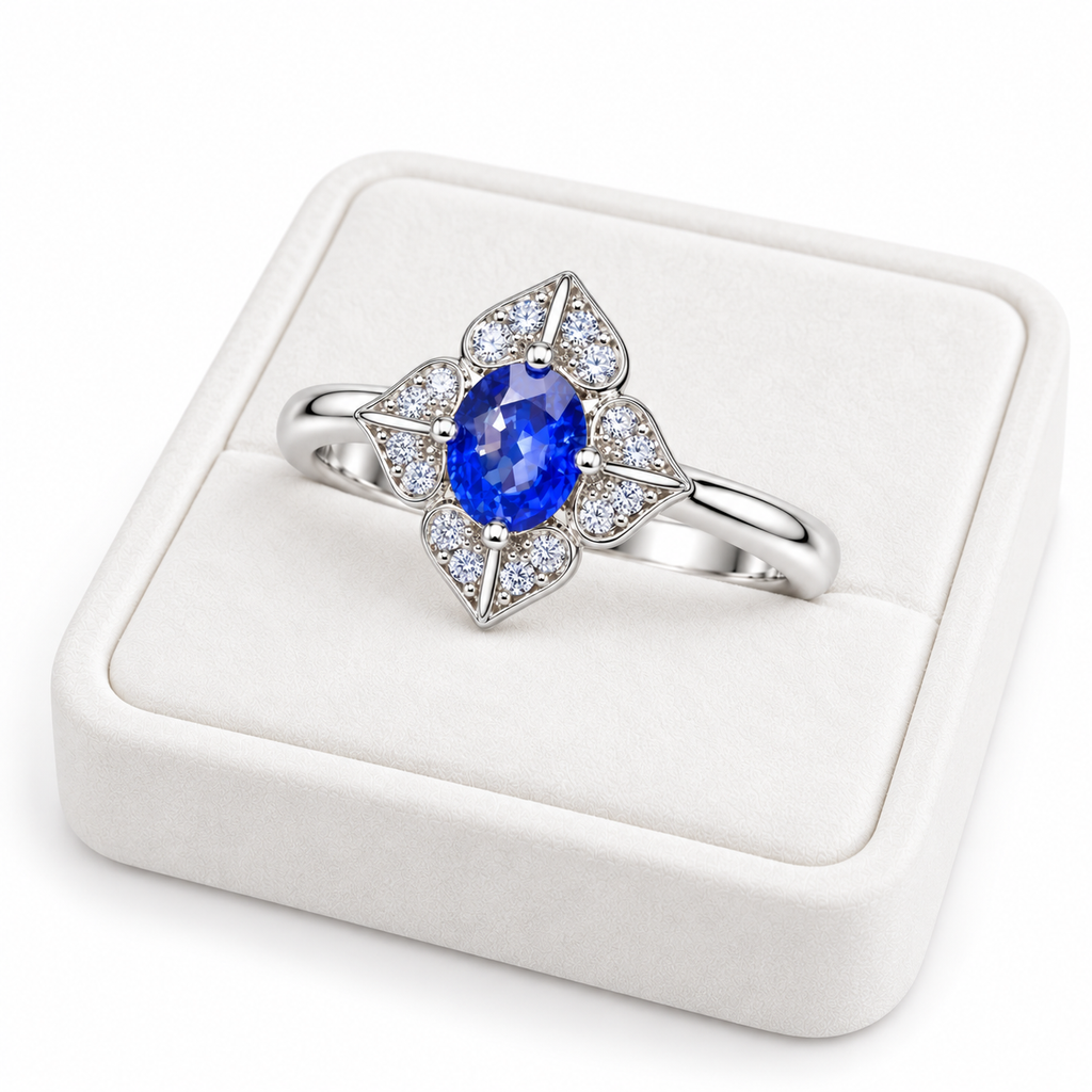 Natural 4×5mm blue sapphire floral ring displayed on a white velvet jewelry tray