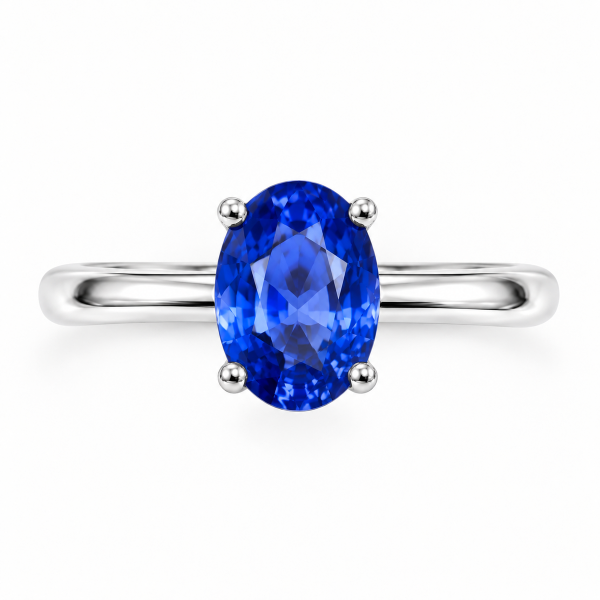 Top-down view of 5x7mm oval sapphire solitaire ring with slim silver band