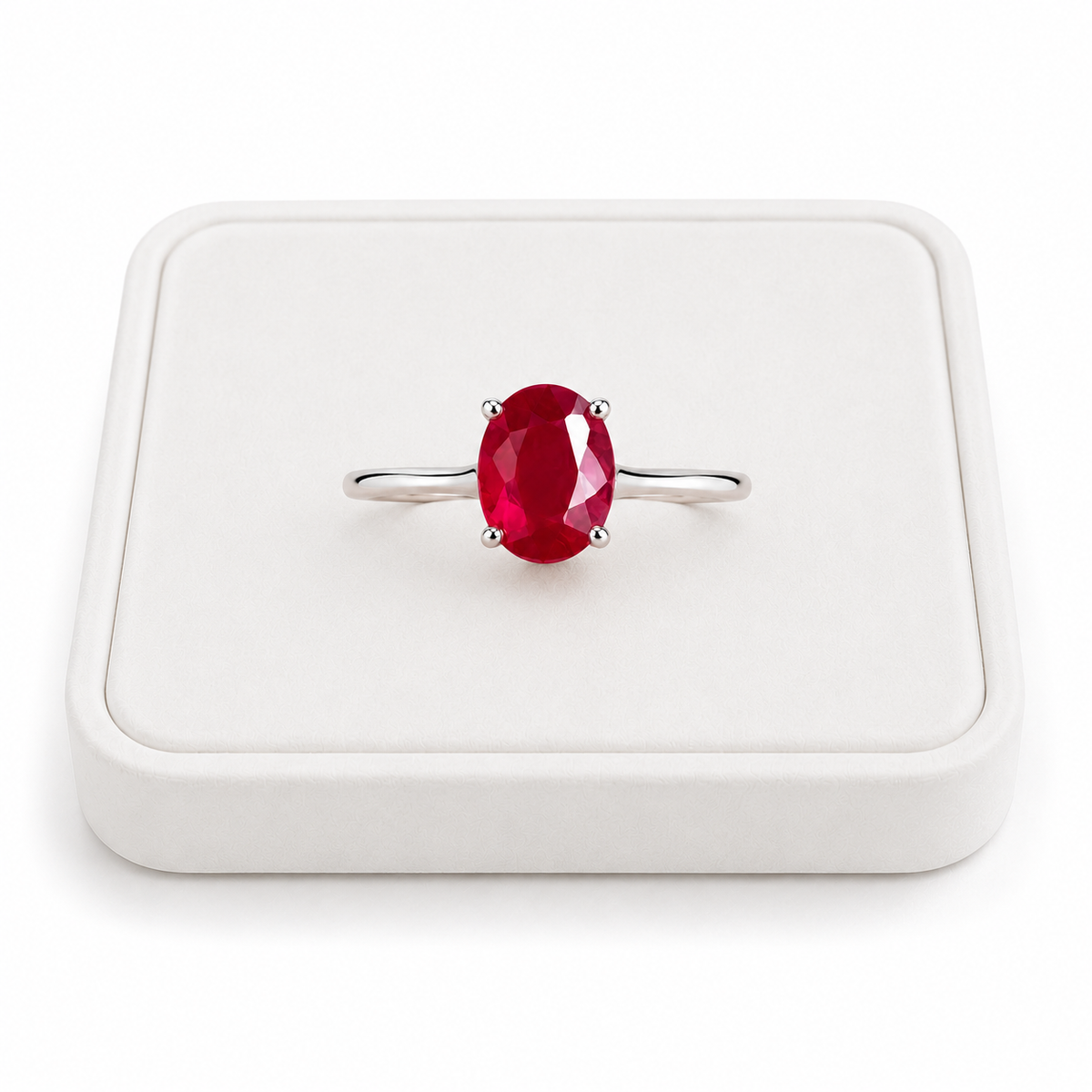 6x8mm oval ruby gemstone ring displayed on white velvet jewelry tray