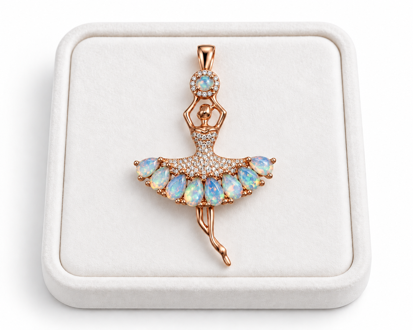 Natural fire opal ballerina pendant displayed on a white velvet jewelry tray