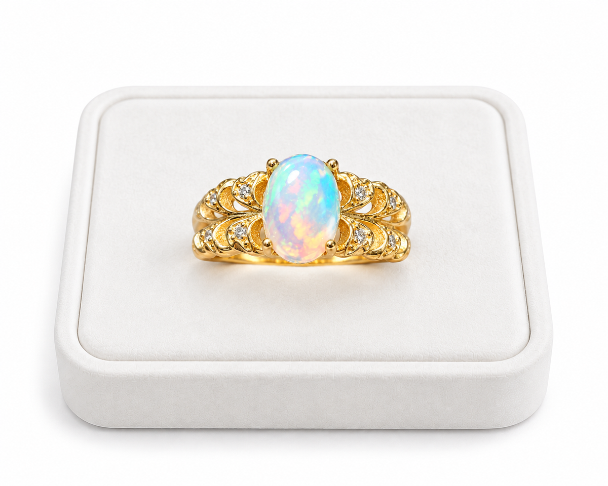 Natural 6x8mm fire opal ring displayed on a white velvet jewelry tray