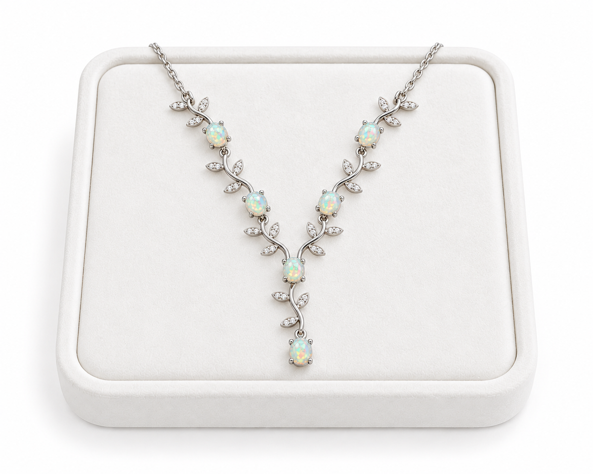 Natural 4x5mm oval opal vine necklace displayed on a white velvet jewelry tray
