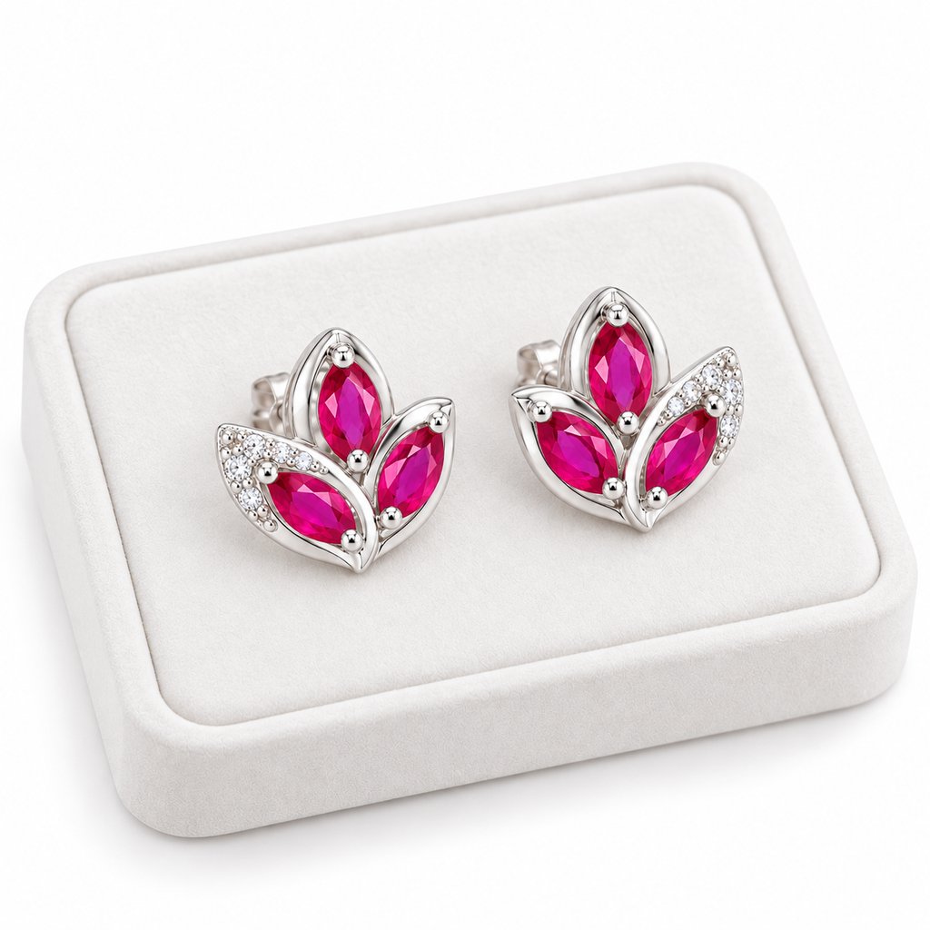 Natural pink ruby marquise stud earrings displayed on a white velvet jewelry tray against a clean white background.