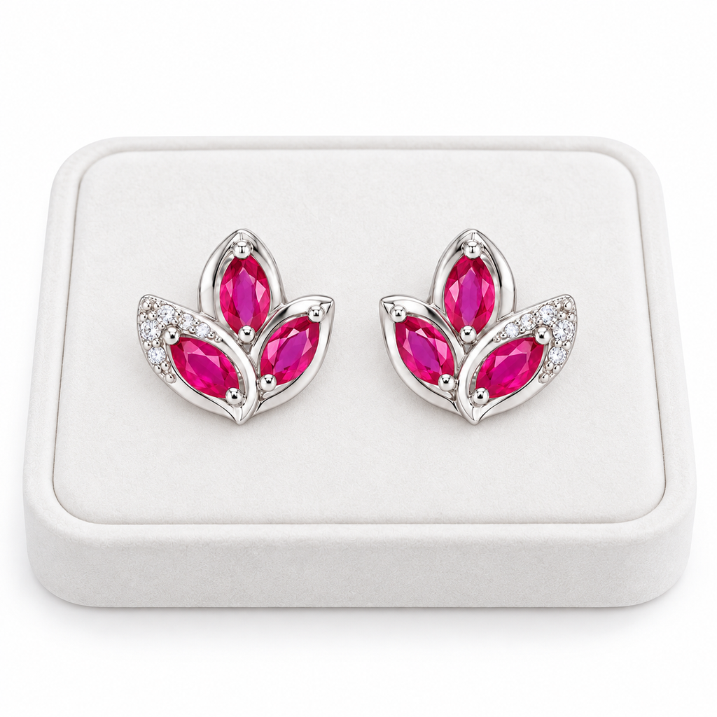 Natural pink ruby marquise stud earrings displayed on a white velvet jewelry tray against a clean white background.
