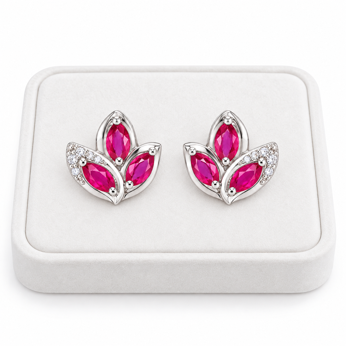 Natural pink ruby marquise stud earrings displayed on a white velvet jewelry tray against a clean white background.