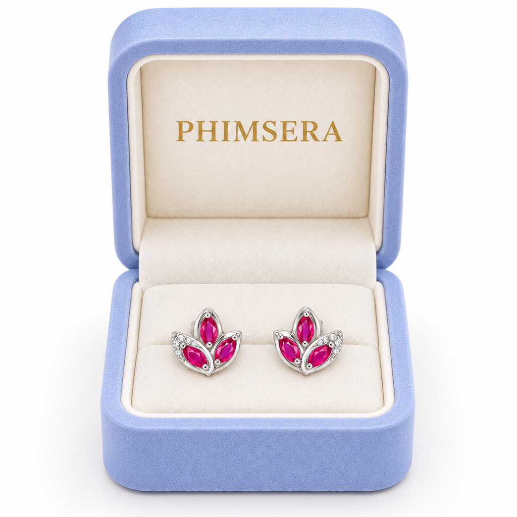 Phimsera natural pink ruby marquise stud earrings presented in an elegant jewelry box with a soft ivory interior.