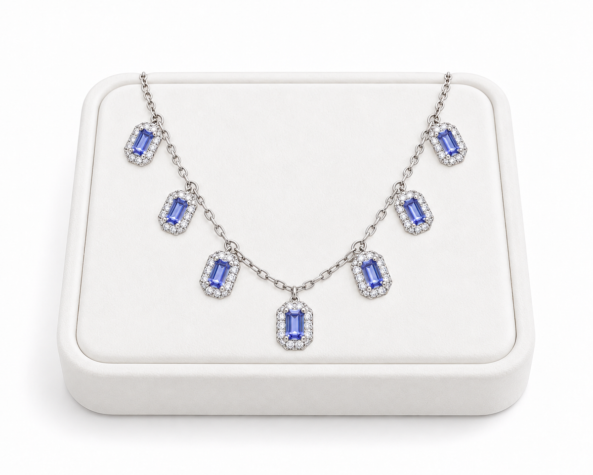 Natural purple tanzanite necklace arranged on a white jewelry display tray with 3×5mm emerald-cut gemstones and 925 Sterling Silver settings.