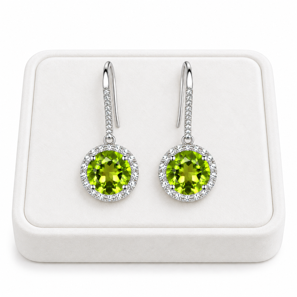 Natural 8mm round peridot drop earrings displayed on a white velvet jewelry tray