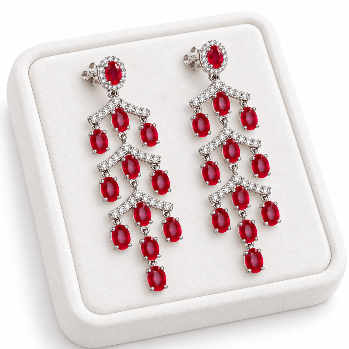 Phimsera natural ruby chandelier earrings displayed on a white jewelry tray, highlighting the cascading ruby and cubic zirconia design.