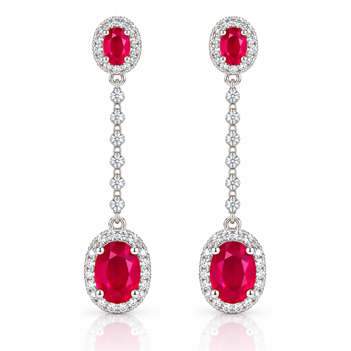 Natural ruby drop earrings featuring graduated 3×4mm and 6×8mm oval red ruby gemstones with clear accent stones by Phimsera