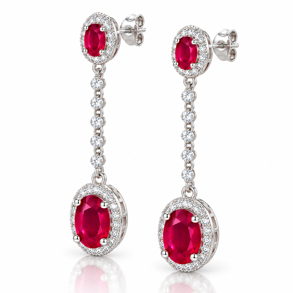 Phimsera natural ruby dangle earrings shown from a 45-degree angle with oval 3×4mm and 6×8mm ruby gemstones