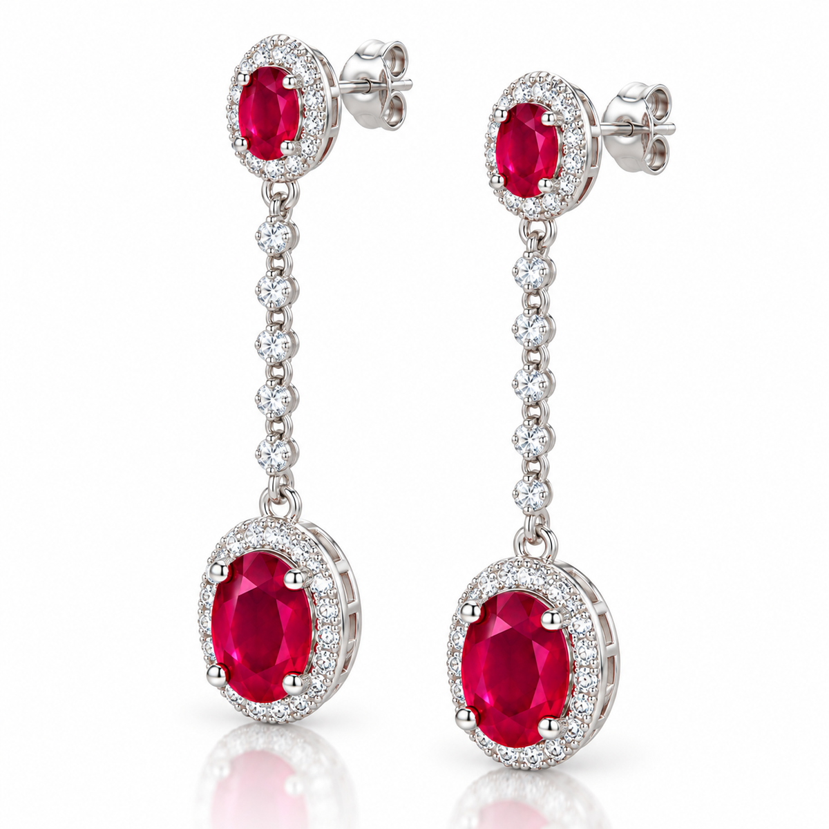 Phimsera natural ruby dangle earrings shown from a 45-degree angle with oval 3×4mm and 6×8mm ruby gemstones