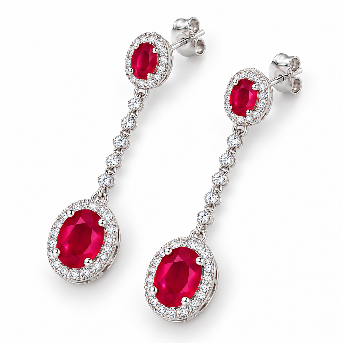 Top-down view of natural ruby drop earrings with graduated oval ruby gemstones and surrounding clear accent stones