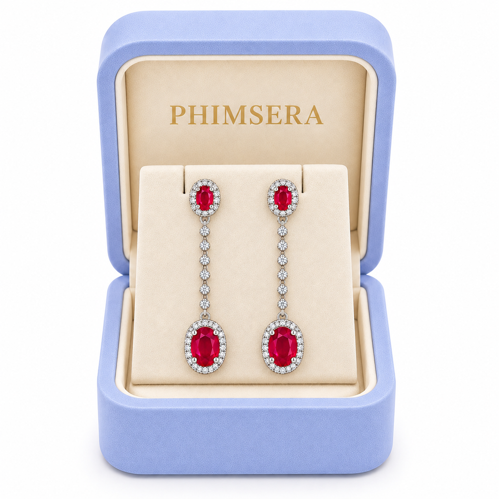 Phimsera natural ruby drop earrings presented in a branded jewelry box