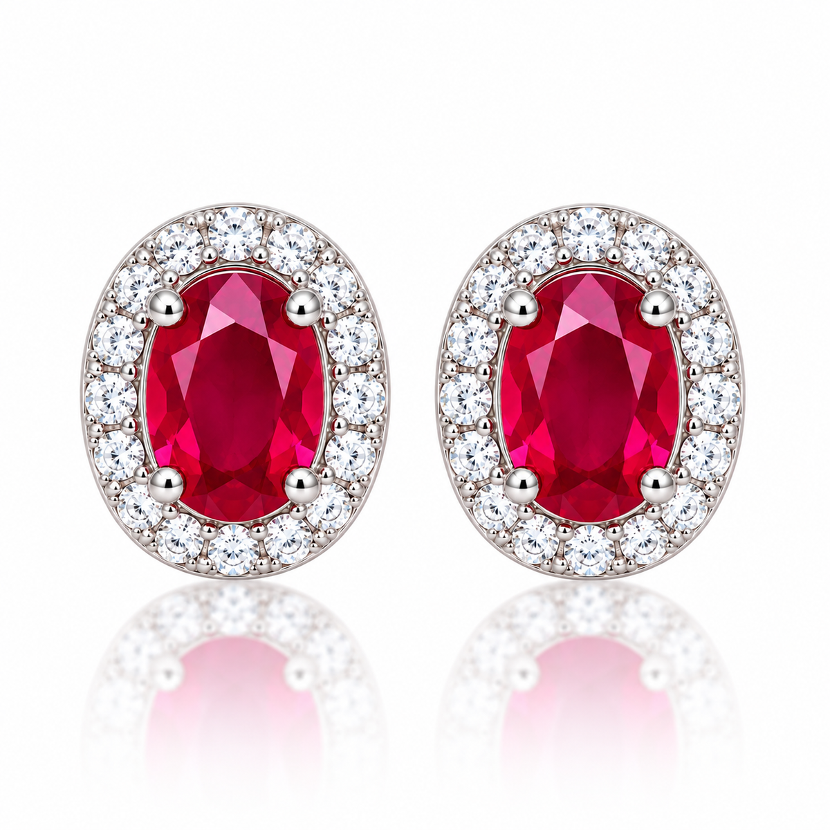 Top-down view of matching natural ruby halo stud earrings with oval 4×6mm ruby gemstones in a silver-tone setting.