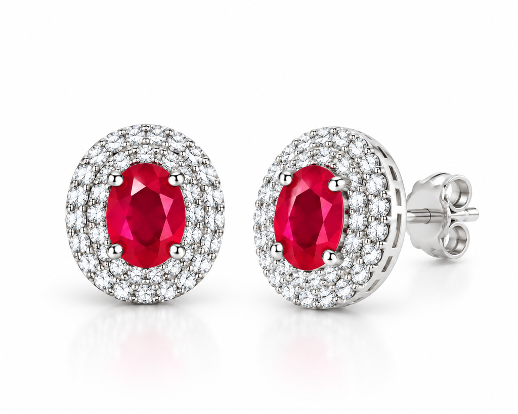 Phimsera 4×5mm oval ruby stud earrings shown at a 45-degree angle, highlighting the natural red ruby center stones and surrounding cubic zirconia halo setting.