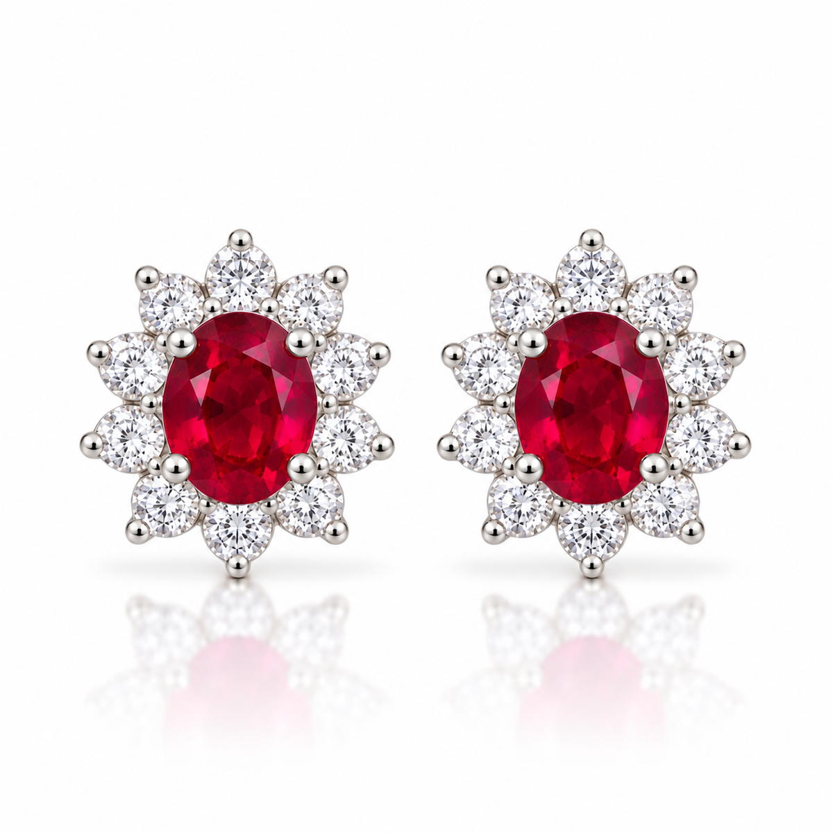 Natural ruby stud earrings with 4 × 5 mm oval red ruby gemstones and floral-inspired clear accent stone halos in 925 sterling silver by Phimsera.