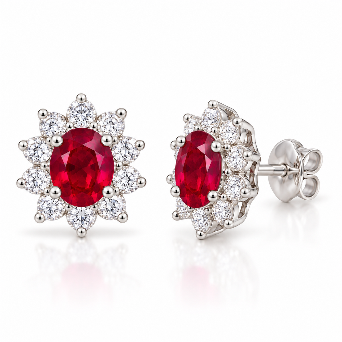 Phimsera natural ruby stud earrings shown at a 45-degree angle, featuring 4 × 5 mm oval ruby gemstones and floral-inspired halo settings.