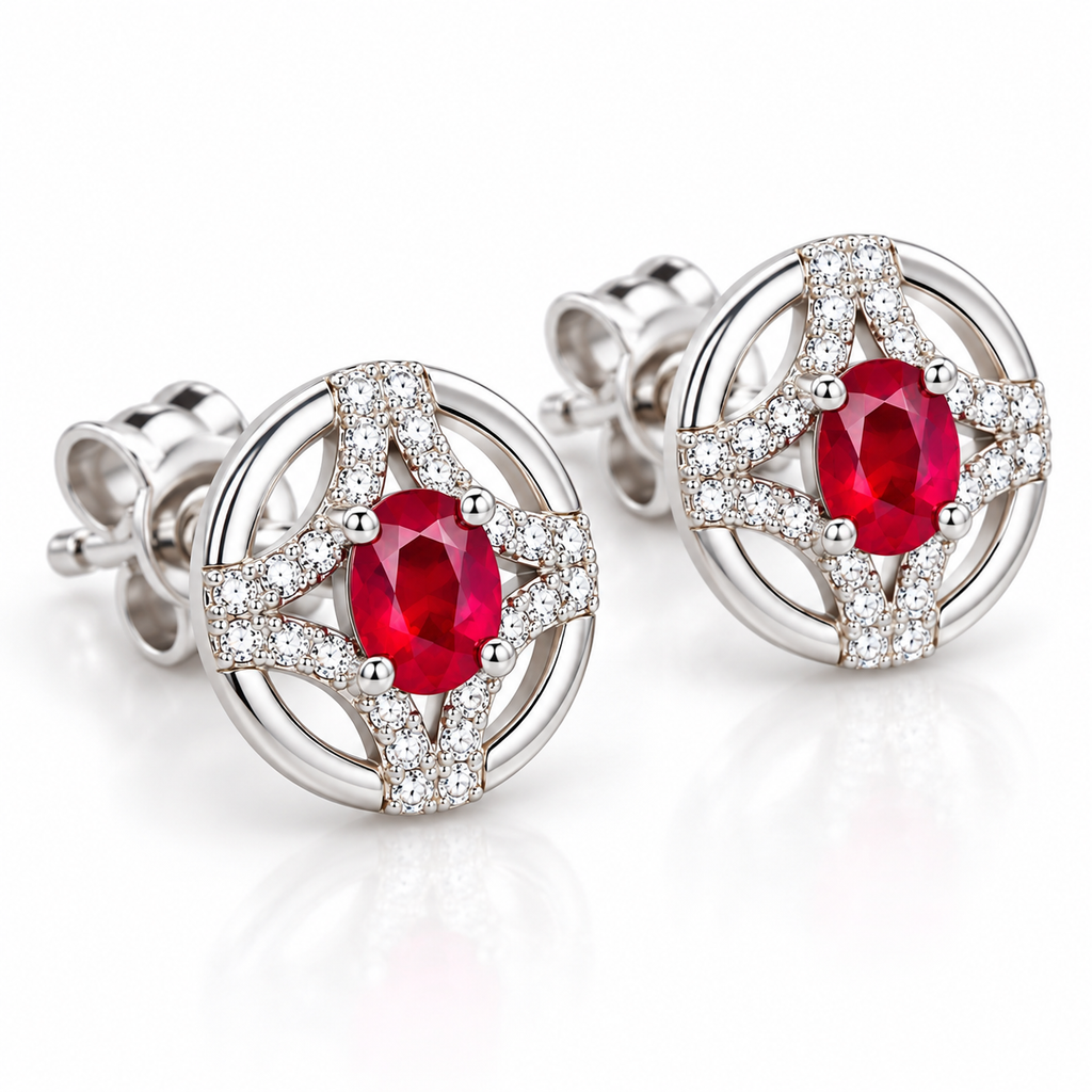 Phimsera 3 × 4mm natural ruby stud earrings shown at a 45-degree angle, highlighting the oval ruby gemstones, circular openwork design, and decorative accent stones.