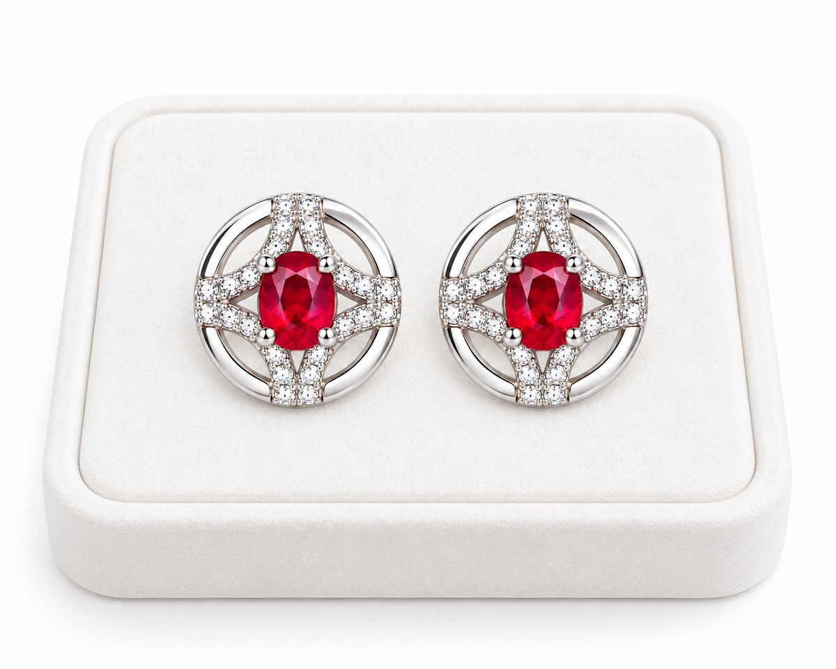 Phimsera 3 × 4mm natural ruby stud earrings displayed on a white velvet jewelry tray against a clean white background.
