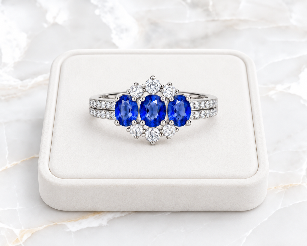 4x5mm blue sapphire ring displayed on a white velvet jewelry tray over white marble