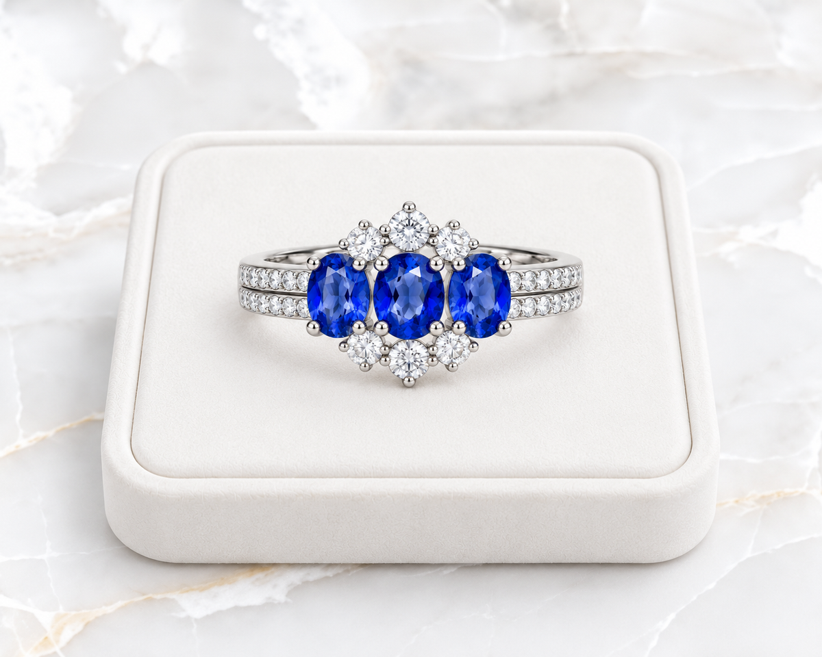 4x5mm blue sapphire ring displayed on a white velvet jewelry tray over white marble