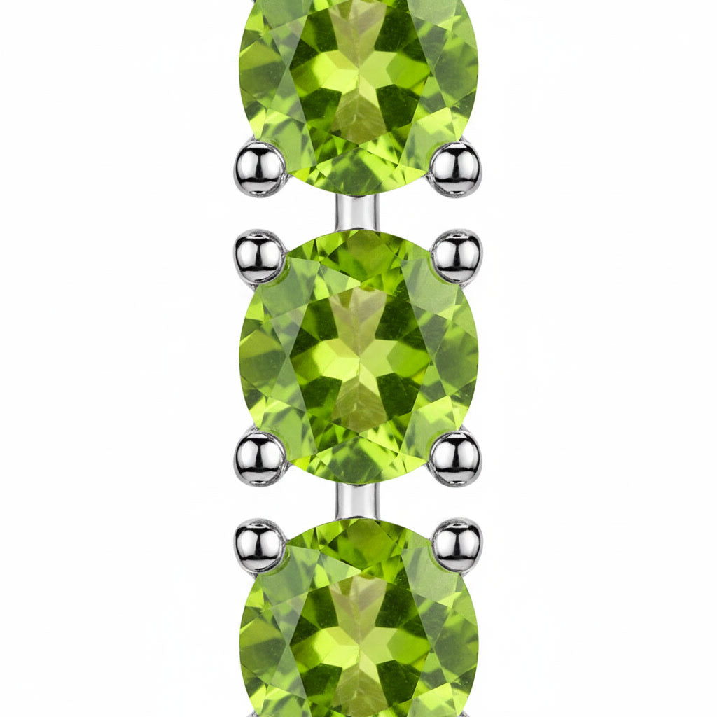 Close-up of faceted 3mm Peridot gemstones and sterling silver settings