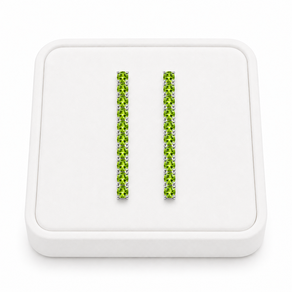 Natural 3mm Peridot dangle earrings displayed on a white velvet jewelry tray
