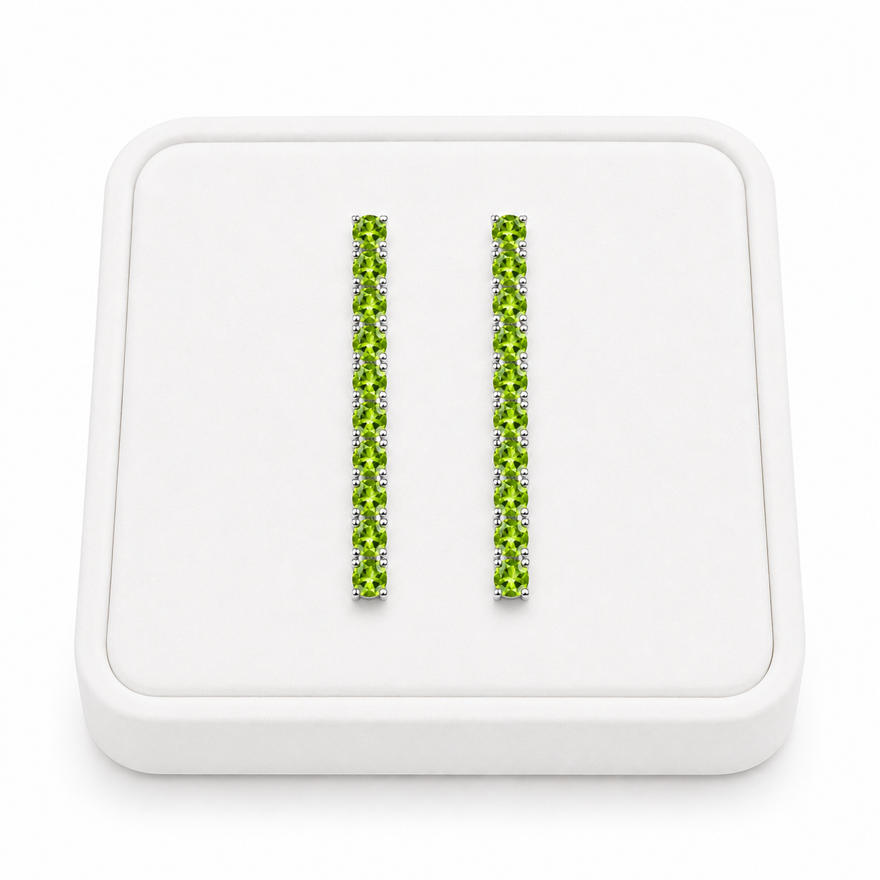 Natural 3mm Peridot dangle earrings displayed on a white velvet jewelry tray