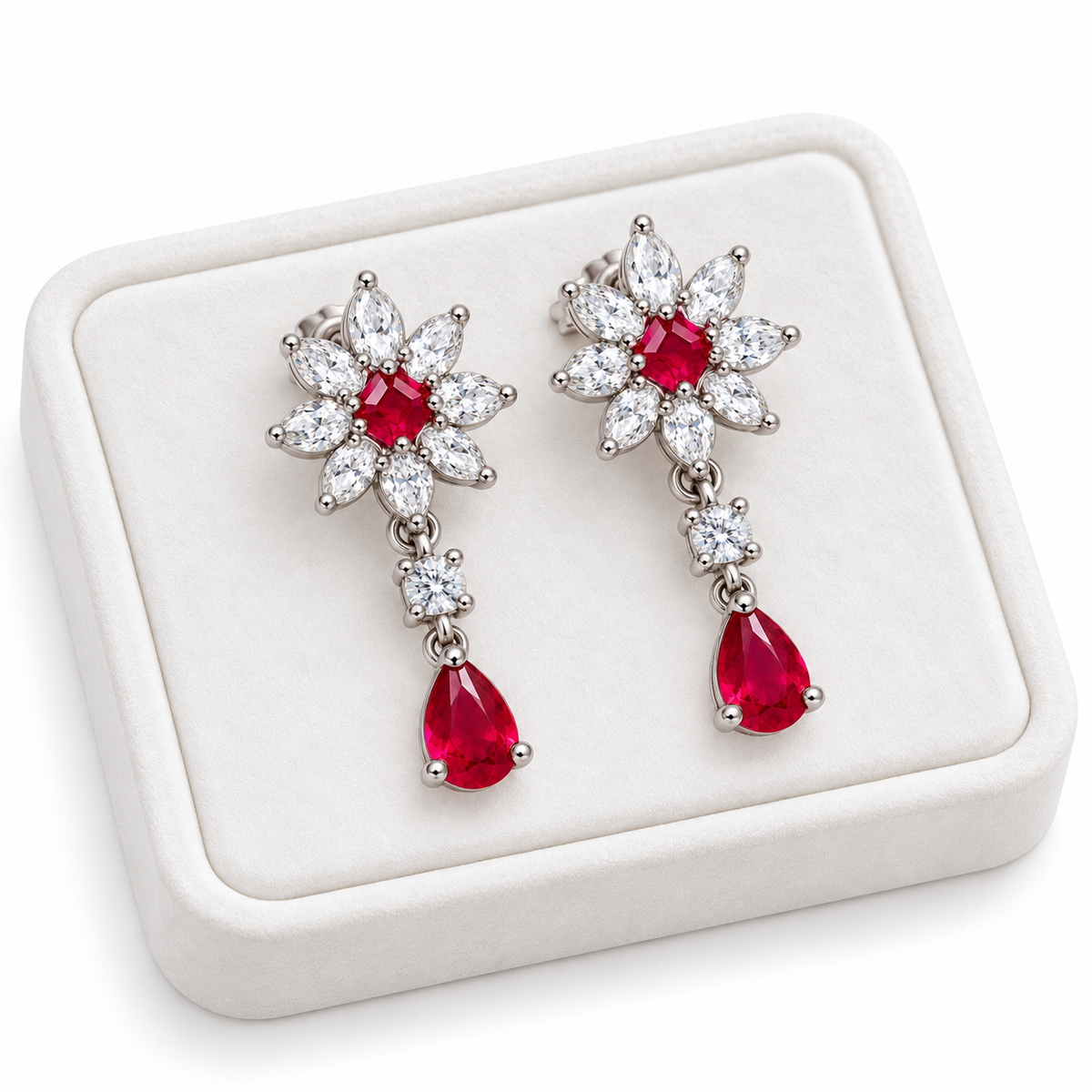 Phimsera natural ruby floral drop earrings displayed on a white velvet jewelry tray with a clean luxury presentation.