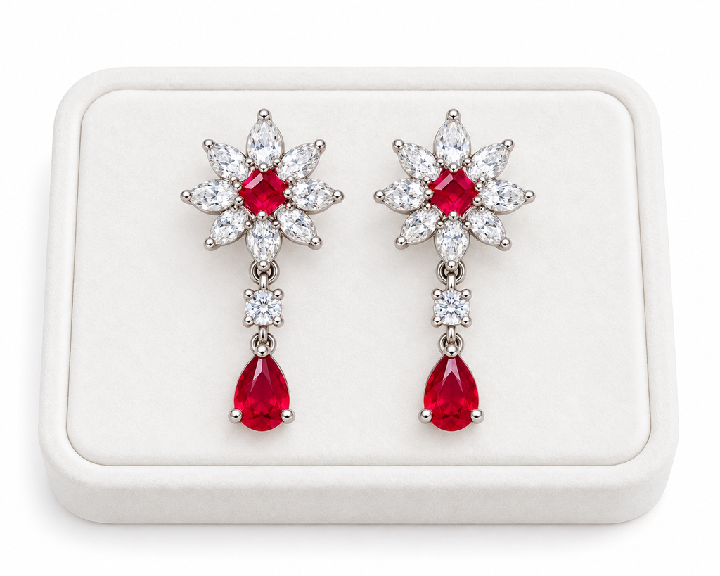 Phimsera natural ruby floral drop earrings displayed on a white velvet jewelry tray with a clean luxury presentation.