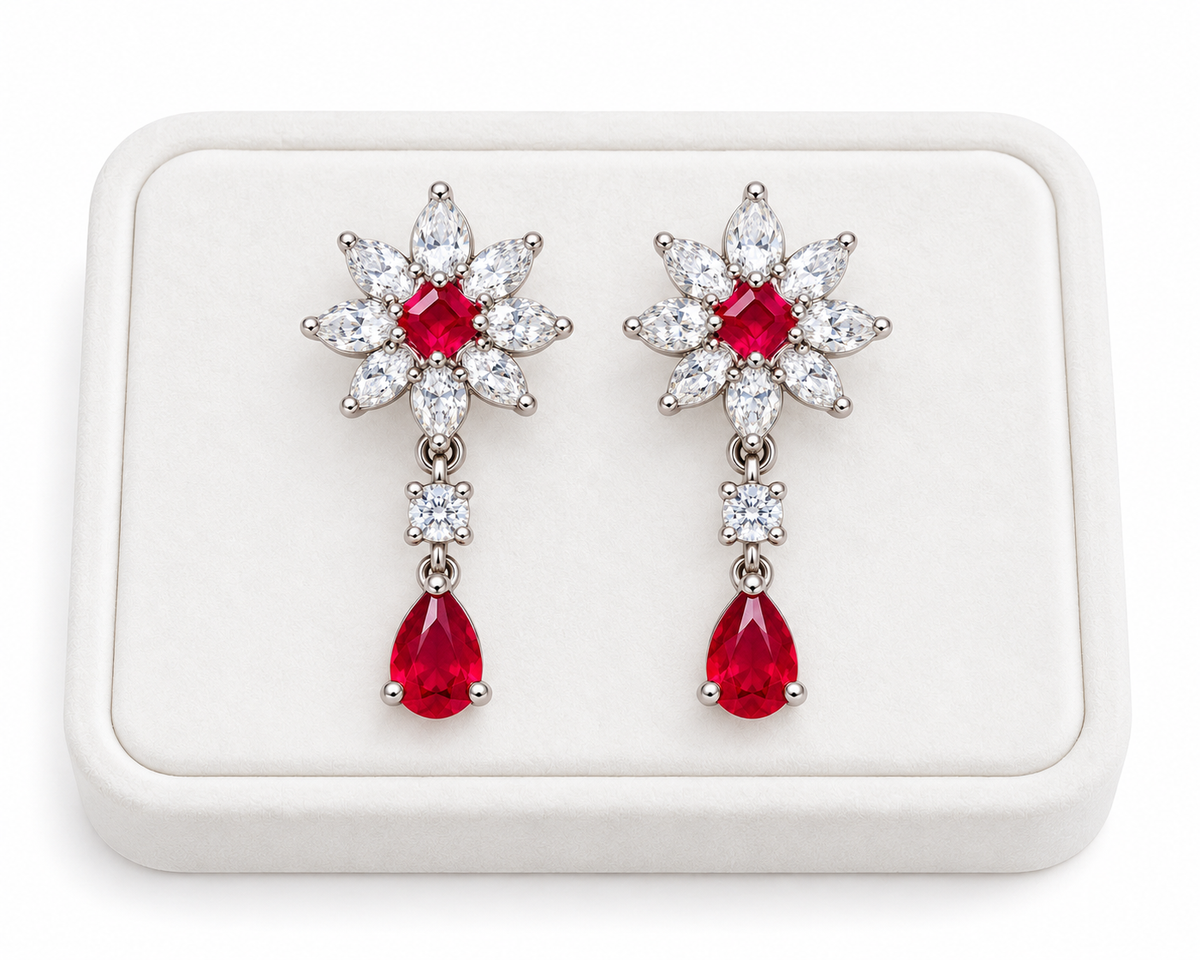 Phimsera natural ruby floral drop earrings displayed on a white velvet jewelry tray with a clean luxury presentation.