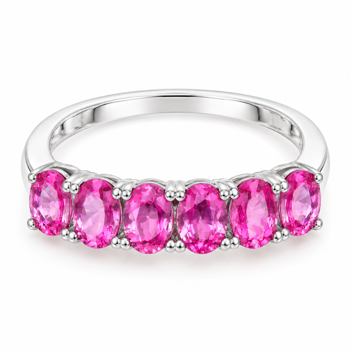 Top-down view of a natural pink sapphire band ring with 3x4mm pink gemstones set in 925 sterling silver.