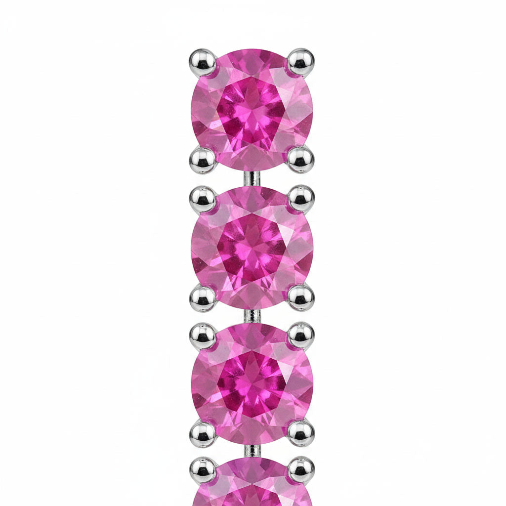Close-up of faceted 3mm Pink Sapphire gemstones and sterling silver settings