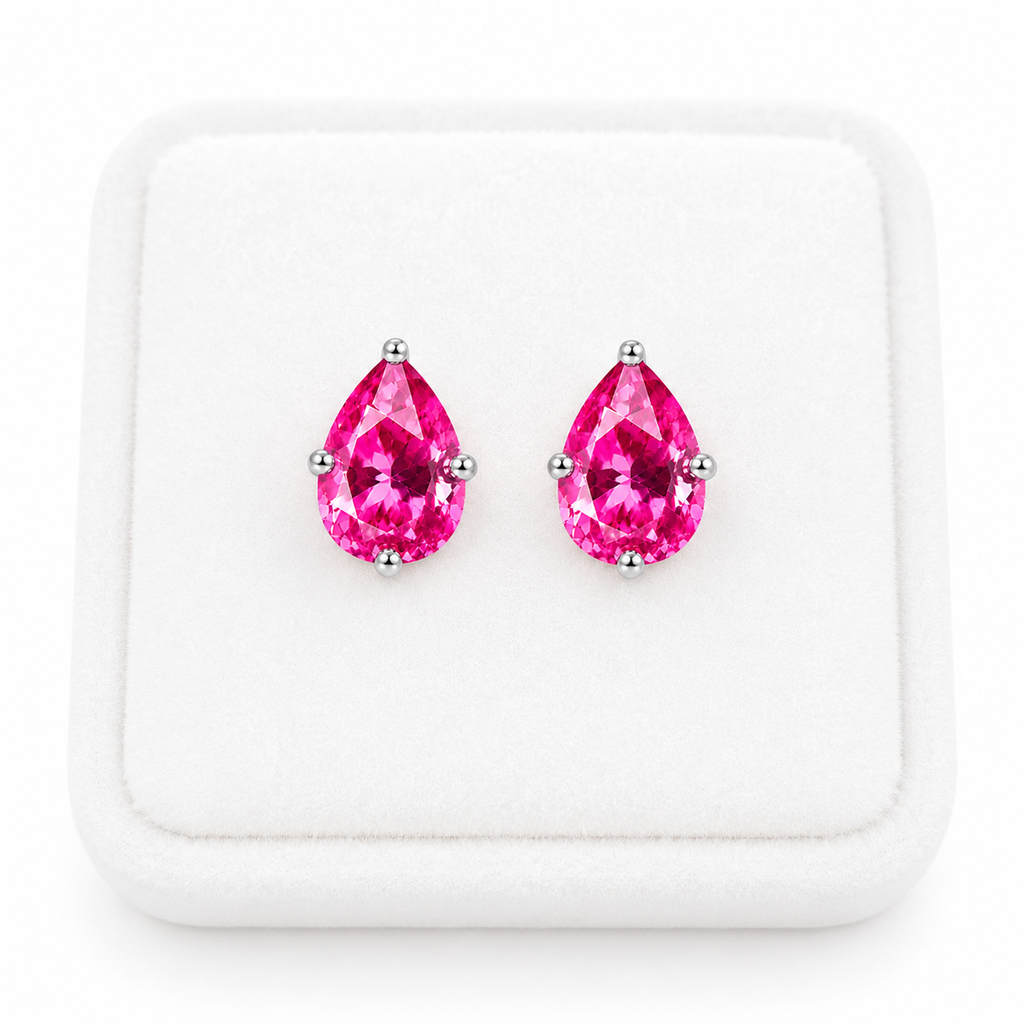 Natural pink topaz pear shaped earrings displayed on white velvet jewelry tray