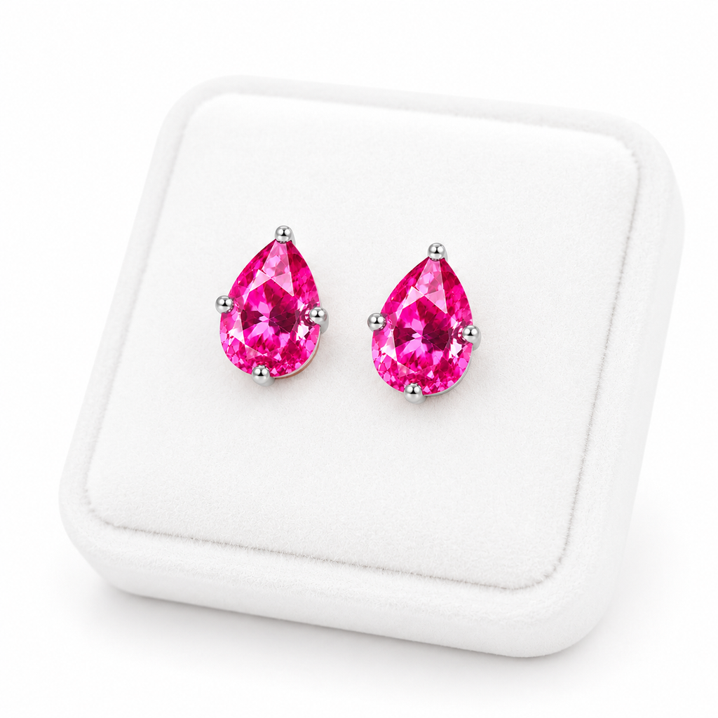 Natural pink topaz pear shaped earrings displayed on white velvet jewelry tray